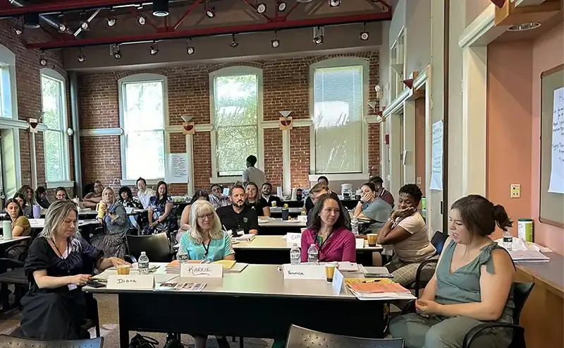 LGH Quest members sitting in a big room together for one of their sessions