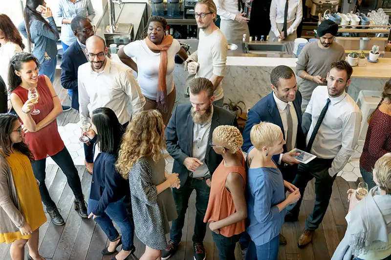 A diverse group or people networking with each other at an event